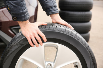 Fototapeta premium Closeup view of man rolling wheel outdoors