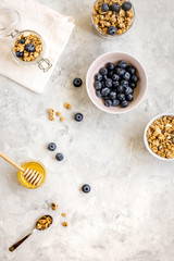 Oat flakes with honey and berries on table background top view