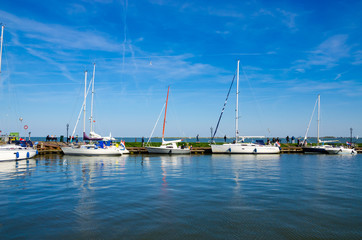 Fototapeta na wymiar Yachts and sail boats in Volendam Harbor, Netherlands