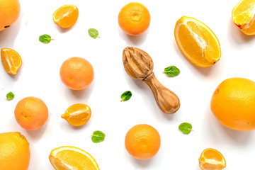 Cut oranges for juicy breakfast on white background top view pattern