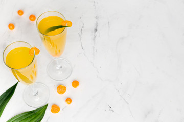 cocktail with physalis in glass on stone background