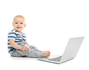 Cute baby boy with laptop on white background