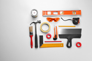 Set of professional decorator equipment on white background
