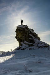 Traveler standing at the top of hill and looking at the amazing landscape.