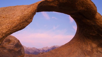 Timelapse of Alpine Peaks thru Arch Rock at Sunrise in Alabama Hills -Pan Left-
