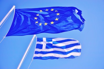 A Greek and European Union (EU) flags flying side by side