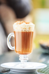 Irish coffee in an outdoor bar. Concept of St Patrick holiday. Holiday background
