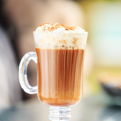 Irish coffee in an outdoor bar. Concept of St Patrick holiday. Holiday background