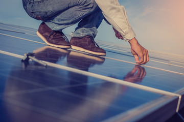 electrician working on  maintenance equipment at solar power plant; electrician swapping  solar...