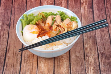 Japanese rice topped boil eggs and fried pork.