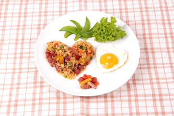 Chinese sausage fried rice and sunny egg in heart shapes.