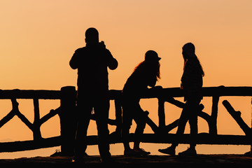 Silhouette people on background red sunset 