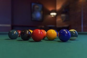 Colorful billiard balls on a green table.