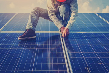 lectrician working on  maintenance equipment at solar power plant; electrician swapping  solar...