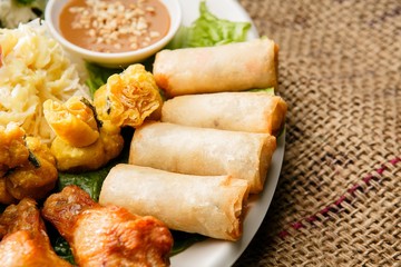 Fresh vegetables, various rolls of meat and crispy fried