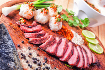 Thai style BBQ  meat with sticky rice and spicy sauce.