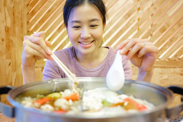 Young woman enjoy eating Shabu-Shabu japanese hot pot