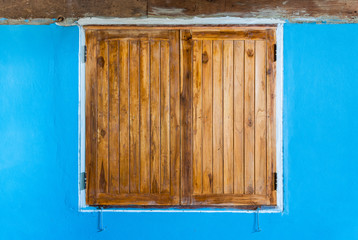 Old Teak Wood Window on Blue Wall