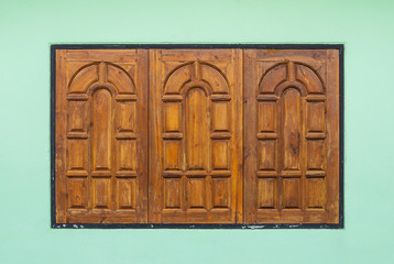 Old Teak Wood Window on Green Wall
