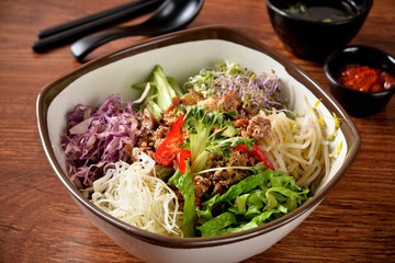 Vietnamese rice bowl with fresh vegetables and meat