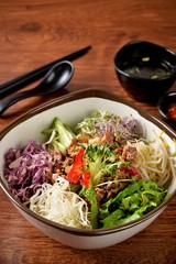 Vietnamese rice bowl with fresh vegetables and meat