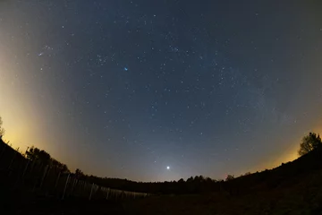 Rolgordijnen Astro landscape with the Milky Way and the bright Venus as seen from the Palatinate Forest in Germany. © David Hajnal