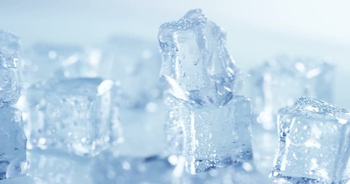 Macro shot of pure water ice cubes that melt in slow motion on white background. Concept: pure mountain spring water, ice, cocktails, fresh and frozen products.