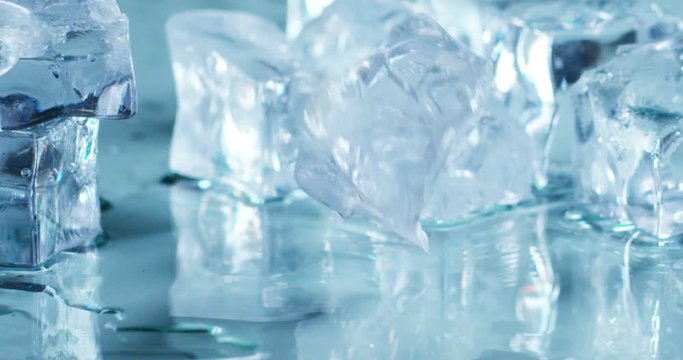 Macro shot of pure water ice cubes that melt in slow motion on white background. Concept: pure mountain spring water, ice, cocktails, fresh and frozen products.