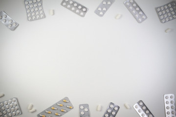 Medical tablets, capsules and pills in blister pack frame as background with copy space for text or image