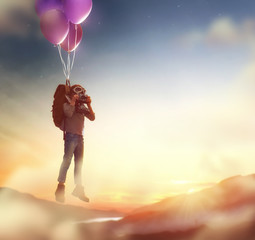 Child flying on balloons