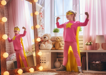 child plays superhero