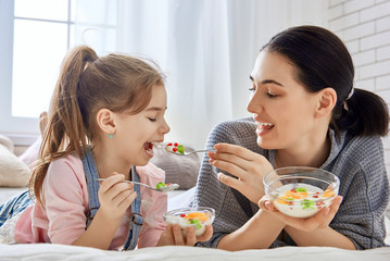 Mother and daughter eating salad