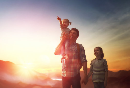 Father and two children at sunset