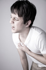 young man having a pain in his breast