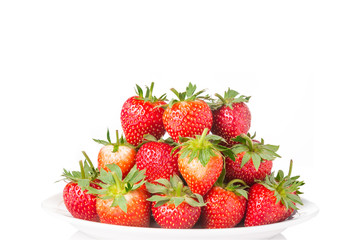 pile of strawberries in a white plate on white background