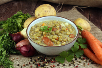 Light summer green pea cream soup in bowl