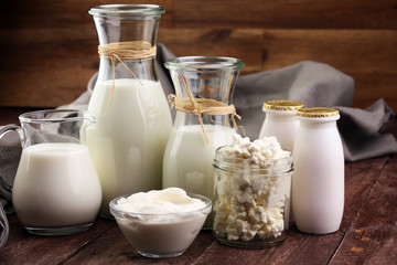 milk products - tasty healthy dairy products on a table on: sour cream in a white bowl, cottage...