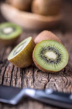 Kiwi Fruit. Several kiwi fruit on oak wooden surface.