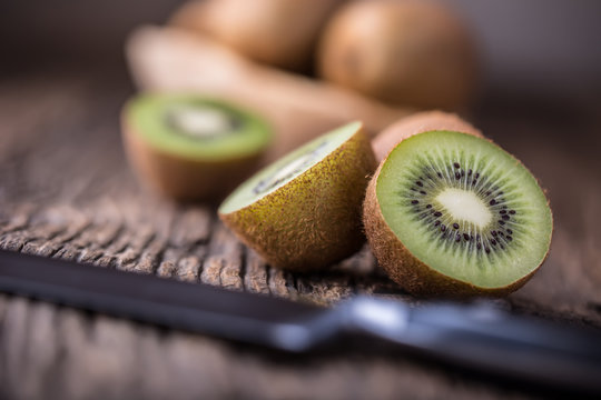 Kiwi Fruit. Several kiwi fruit on oak wooden surface.