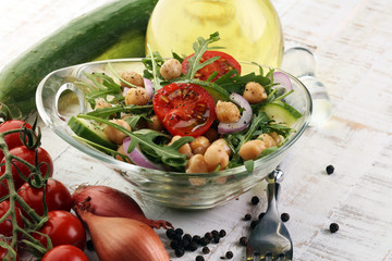Healthy homemade chickpea and veggies salad, arugula, diet, vegetarian, vegan food, vitamin snack