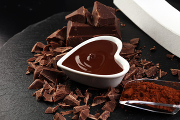 Melting chocolate / melted chocolate/ chocolate swirl/ stack/ chips and powder. Love concept. Valentine's Day Concept.