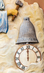 Fototapeta na wymiar hand holding hammer on clock and bell
