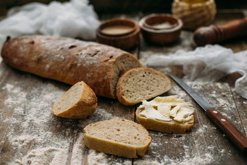 Butter and bread for breakfast over rustic wooden background