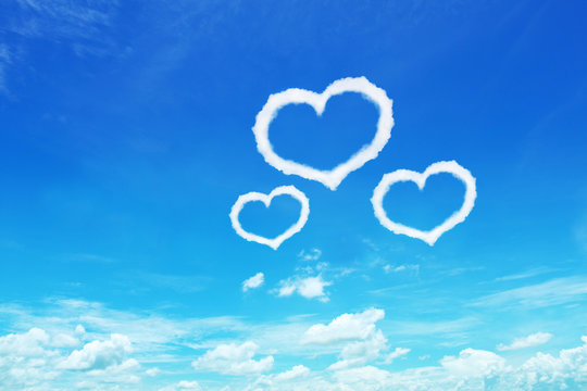 three heart shaped clouds on blue sky for design
