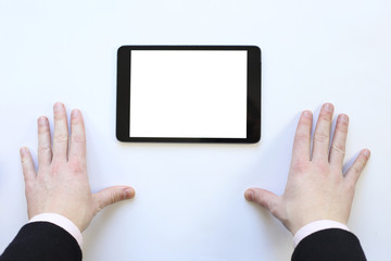 the tablet on white table. Top view.