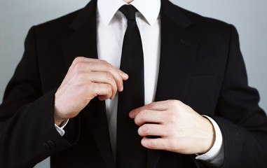business man in a black suit. correct clothing