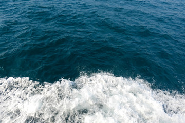 Deep blue sea and white water splash