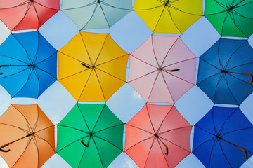 Colorful umbrellas on blue sky