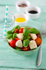 caprese salad on turquoise background