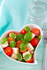 caprese salad in a heart-shaped bowl